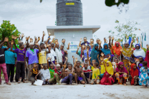 Lalji foundation team with Mdimni Villagers in front of a clean water borewell project