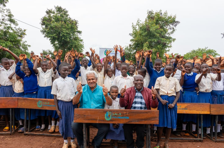 Kasulu primary school students celebrating their new school desks

